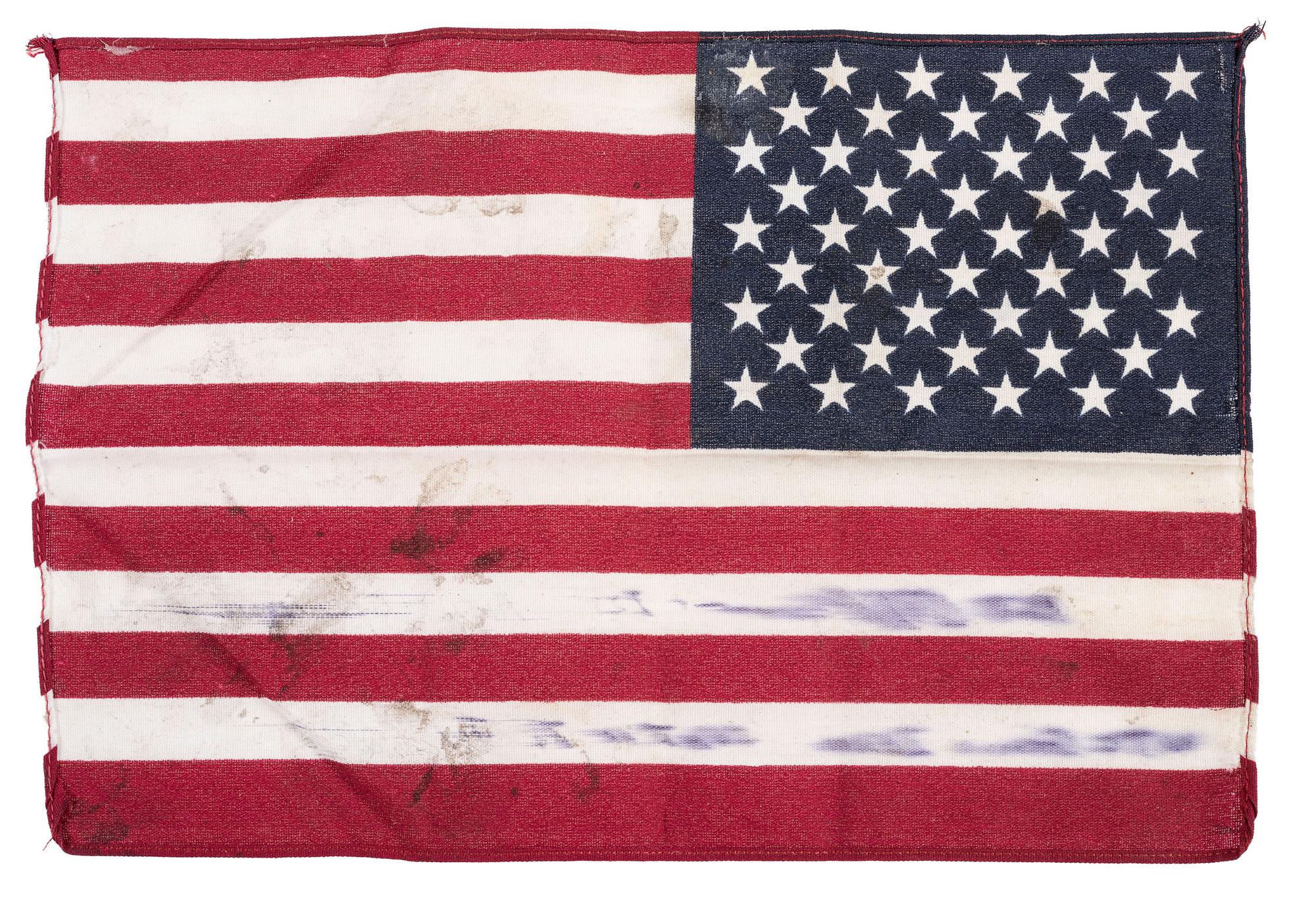 [FLAGS]. A group of items related to the recovery efforts at Ground Zero after September 11, 2011, incl. a helmet worn at the site by retired NYC Detective Arthur Giammarino as he assisted in the recovery efforts.