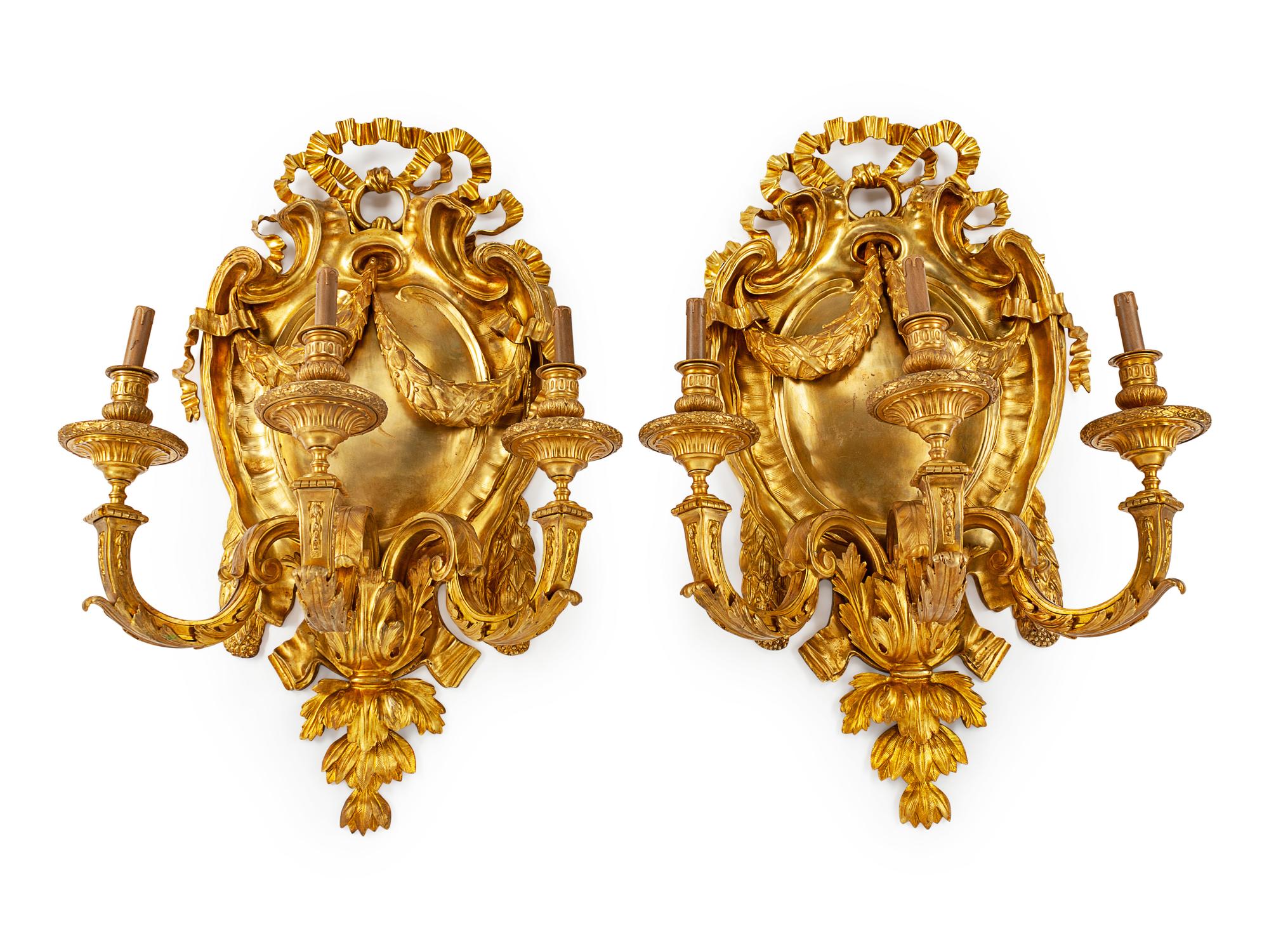 A Pair of Large Gilt Metal Shield-Form Three-Light Sconces