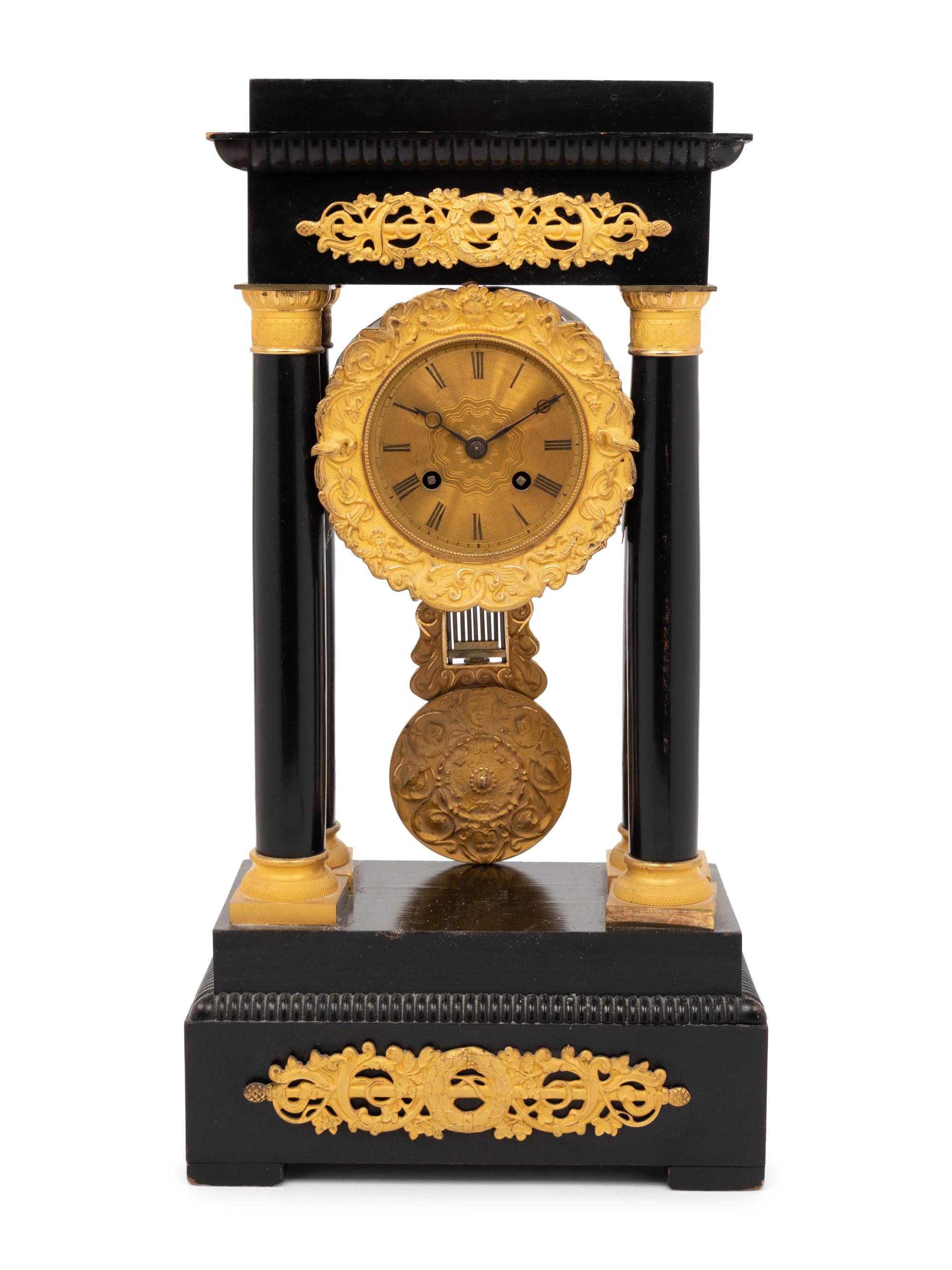 An Empire Style Gilt Bronze Mounted Ebonized Portico Clock