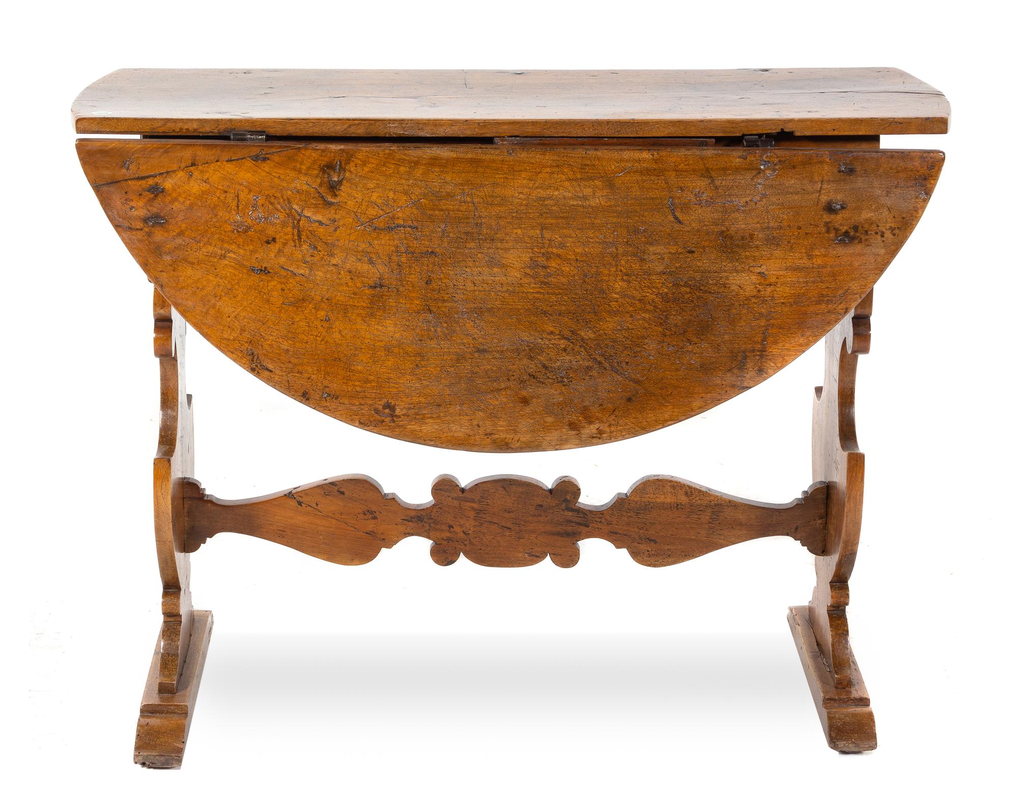 An Italian Walnut Drop-Leaf Table Height 32 x width 43 x depth 15 1/4 inches (closed). — 18TH CENTURY