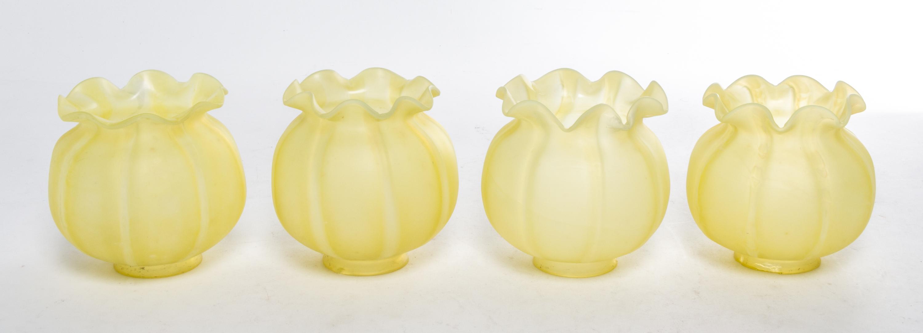 A Set of Four Yellow Glass Shades Height 5 inches.