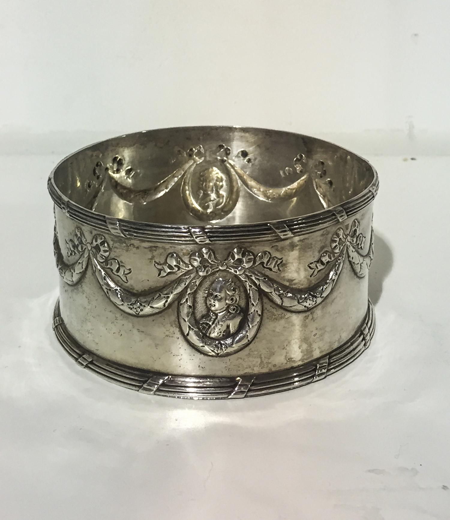 A German Silver Wine Coaster, Maker's mark SB below a crown, post-1890, chased with garlands suspending portrait medallions above a tie