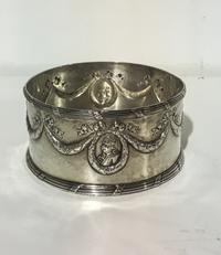 A German Silver Wine Coaster, Maker's mark SB below a crown, post-1890, chased with garlands suspending portrait medallions above a tie
