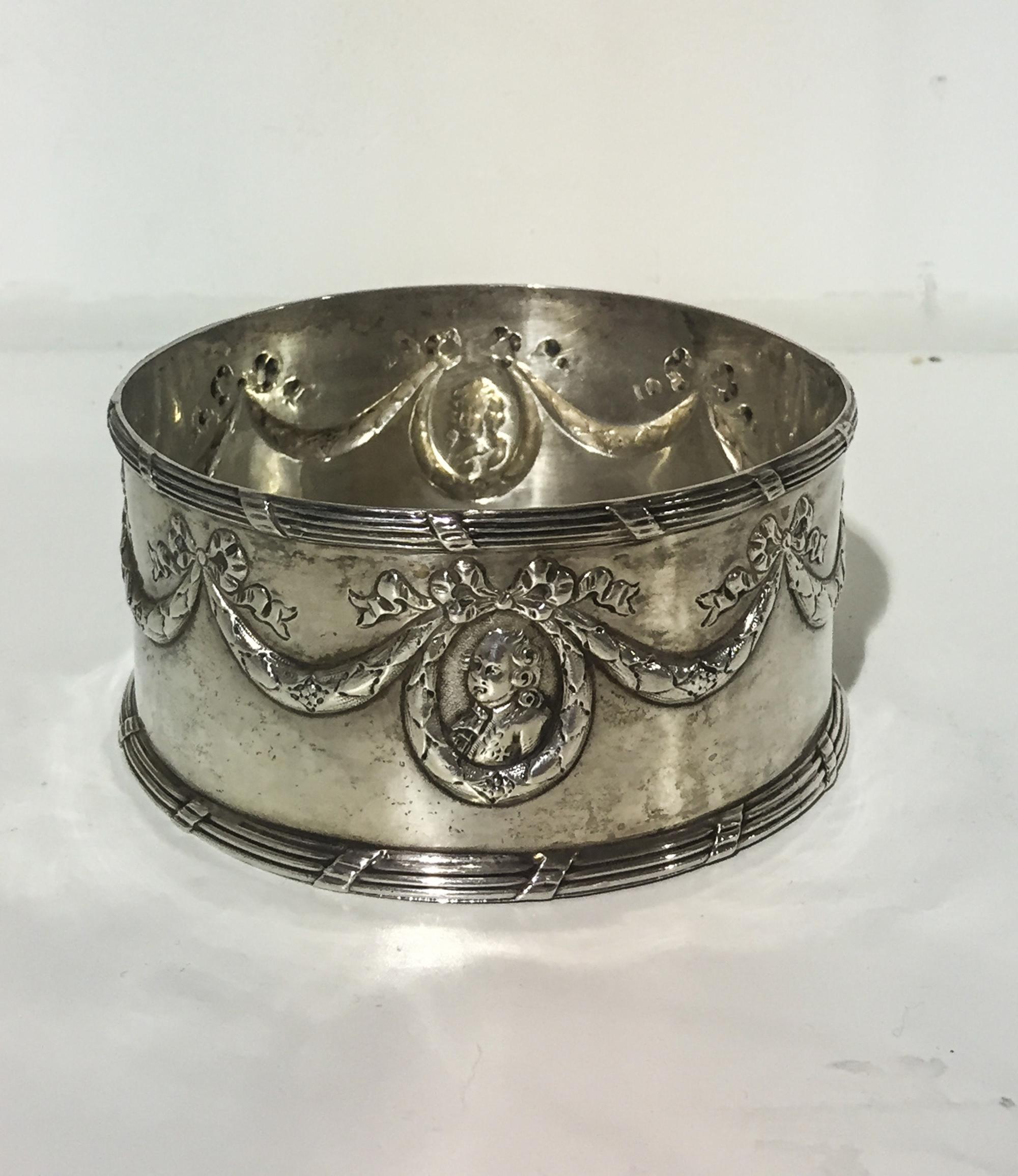 A German Silver Wine Coaster, Maker's mark SB below a crown, post-1890, chased with garlands suspending portrait medallions above a tie