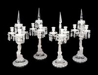 A Set of Four Baccarat Dauphin Three-Light Candelabra
