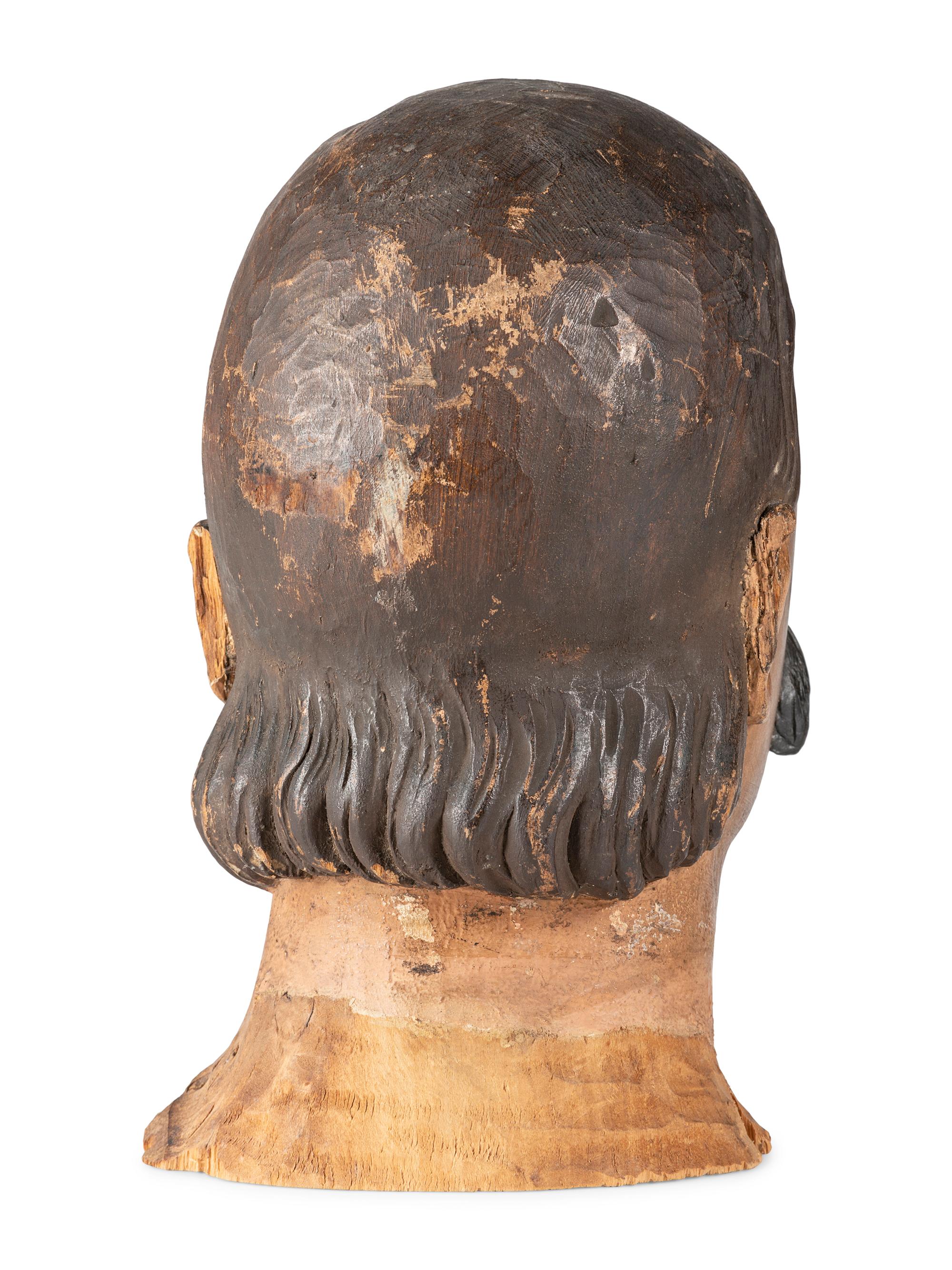 A Carved and Painted Wood Head of a Mustachioed Man
