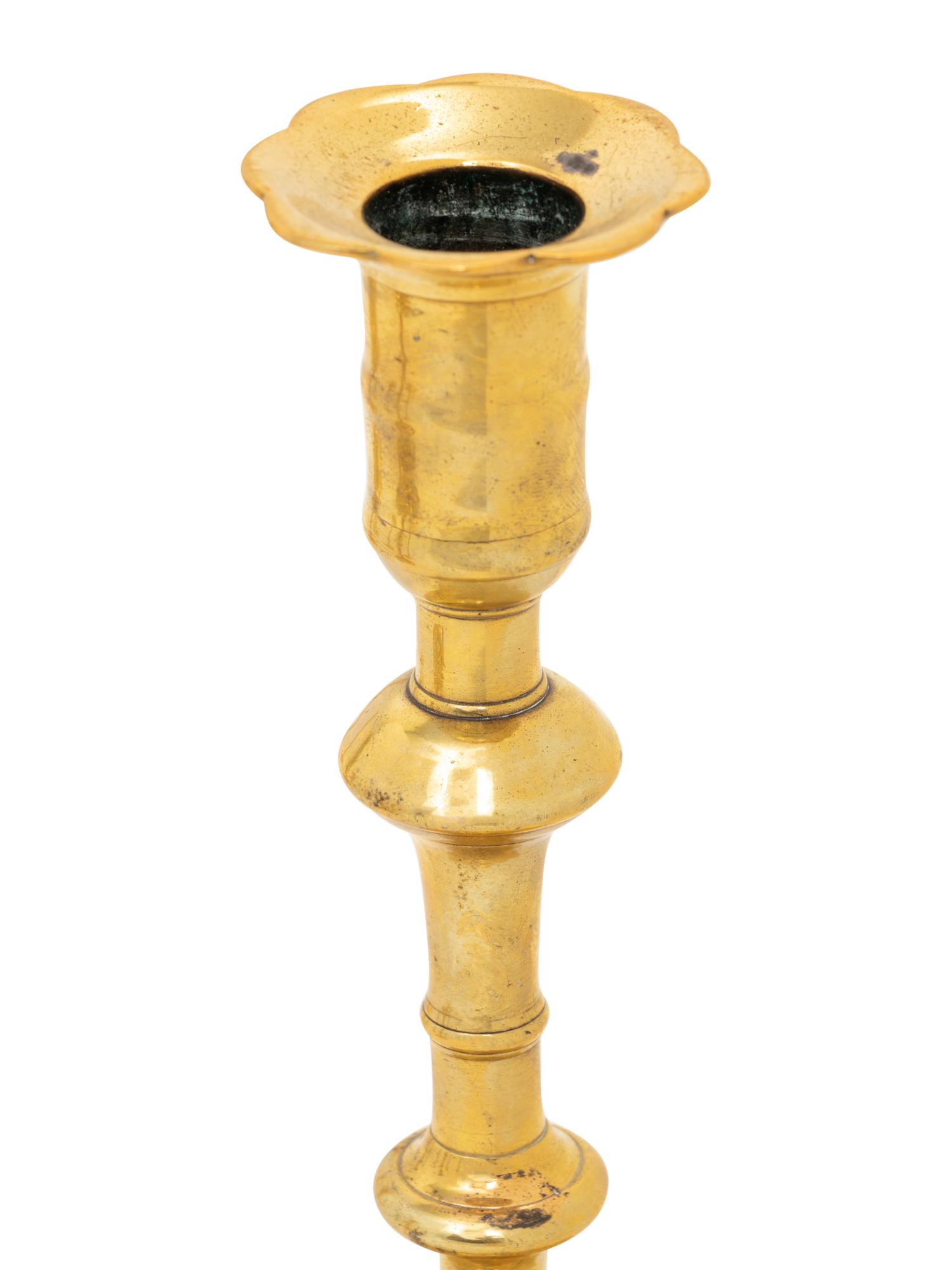 A Group of Eight English Brass Candlesticks