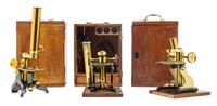 A Group of Three Brass and Black Lacquered Microscopes Height of largest case 10 1/2 inches. — J. F. SLUGG, MANCHESTER, 19TH CENTURY AND OTHERS