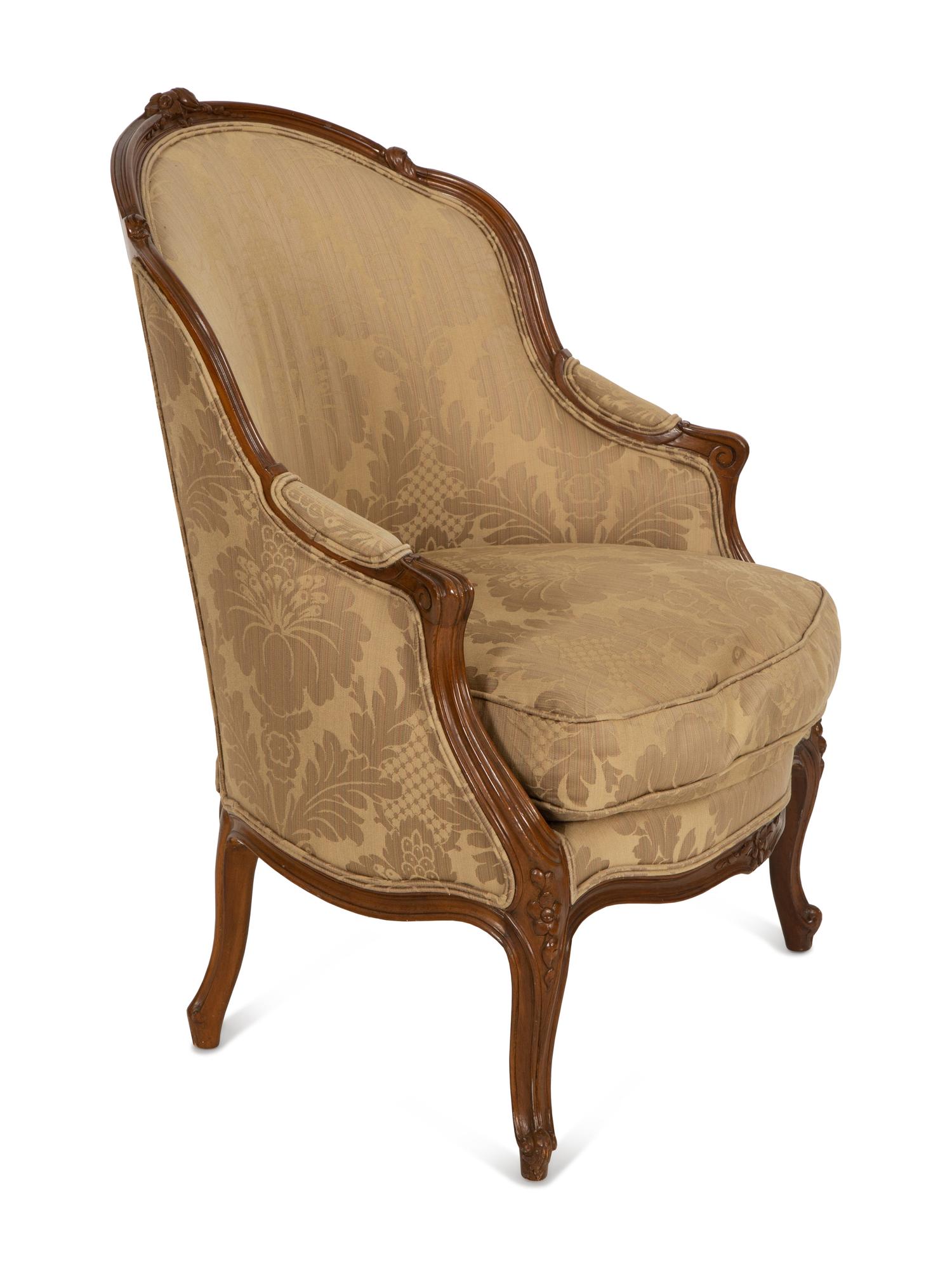A Louis XV Style Carved Walnut Bergère