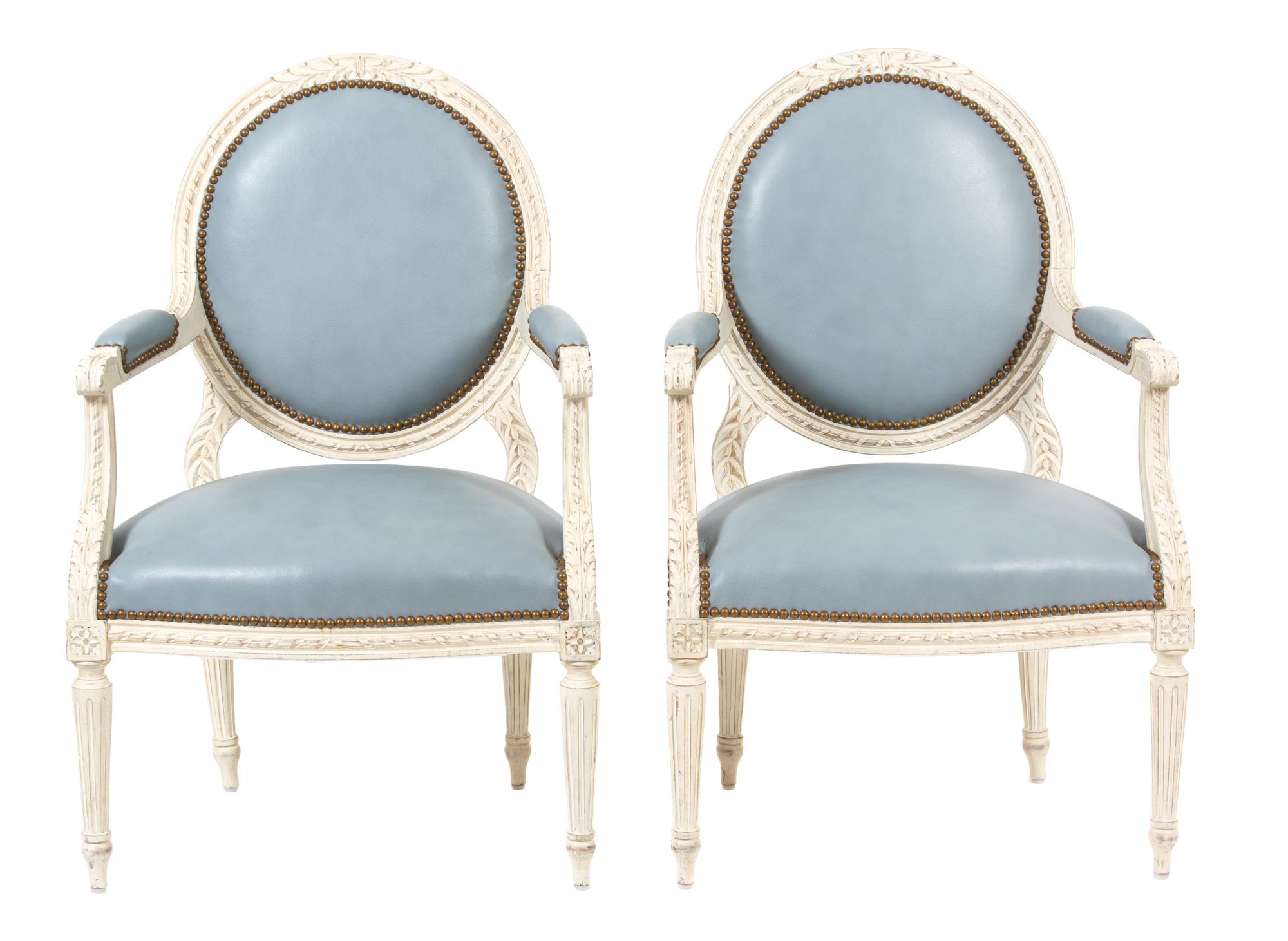A Pair of Louis XVI Style Carved and Painted Oval Back Fauteuils Height 35 inches. — 20TH CENTURY