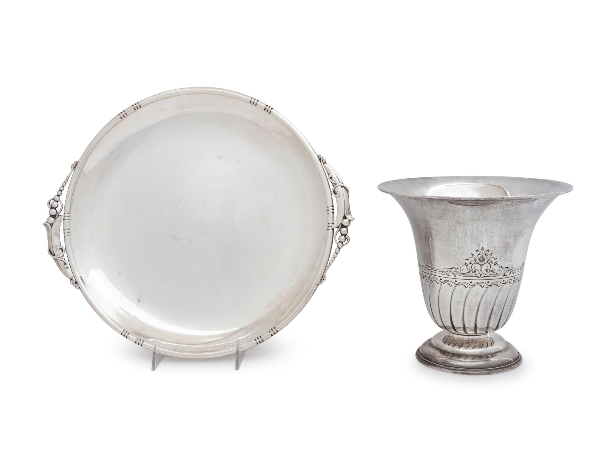 comprising a J. Wagner & Sons serving dish, Birks Silver Co. tazza, Tuttle Silversmiths vase, Dingwall sugar basket, Gorham nut dish, English bread dish and sauce boat, caster, salt cellar, three weighted candlesticks and a weighted vase, together with a silver-plate ice bucket. 15 items total.