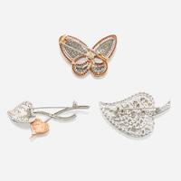 A collection of three gold and gem-set brooches