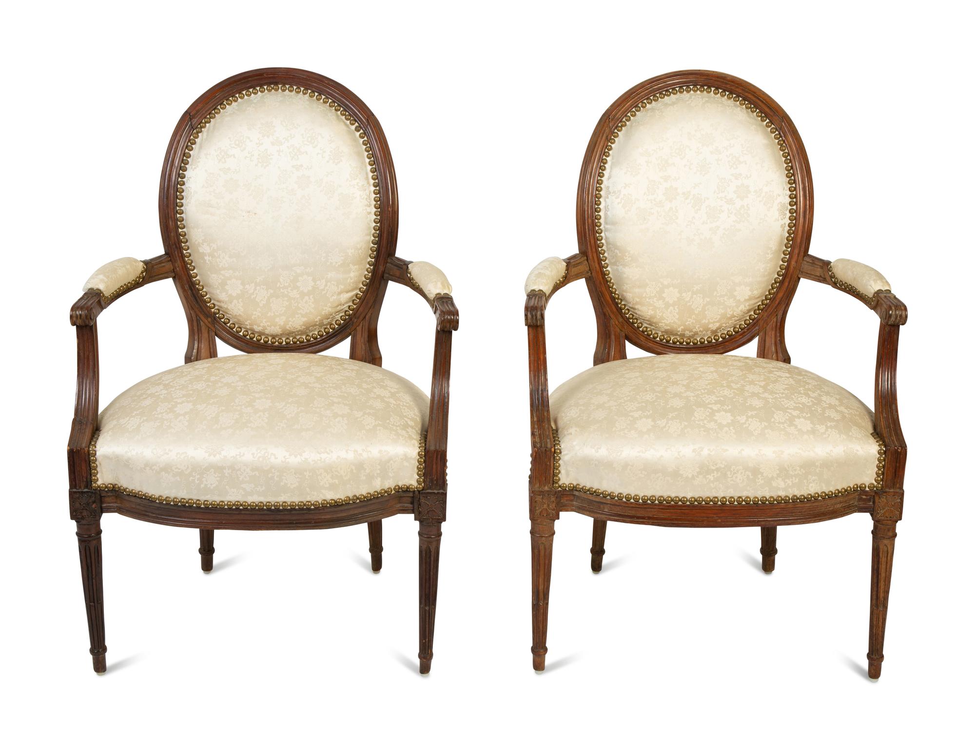 A Pair of Louis XVI Walnut Fauteuils en Cabriolet