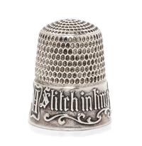 An American Silver Thimble, Simons Bros., Philadelphia, PA, the based marked A Stitch in Time Saves Nine with a vacant cartouche framed
