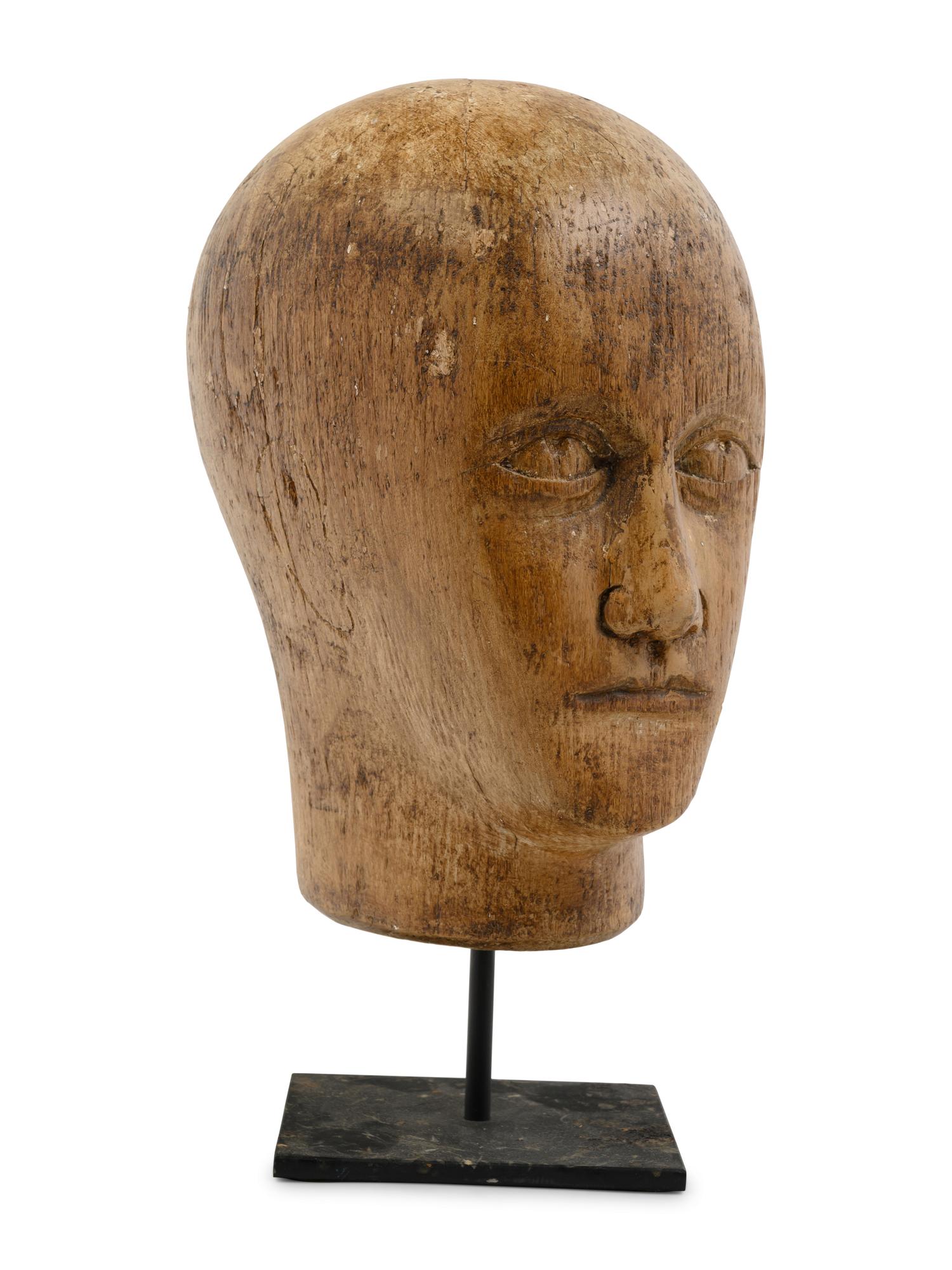 A Carved Wood Mannequin Head