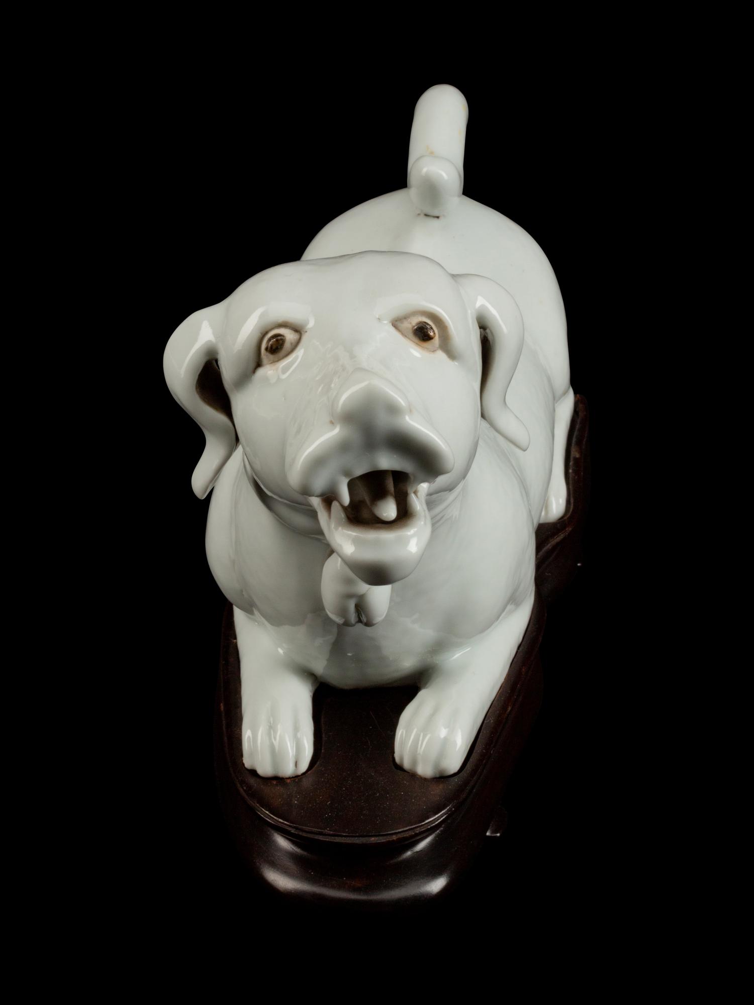 A Chinese Export Blanc de Chine Porcelain Figure of a Recumbent Dog — 19TH CENTURY