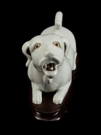 A Chinese Export Blanc de Chine Porcelain Figure of a Recumbent Dog — 19TH CENTURY