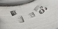 A Pair of Russian Silver Candlesticks, Maker's Mark Obscured, 1835, each set on a circular base bearing a monogram and coronet over fol