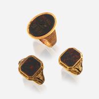 A collection of three gold and bloodstone men's rings