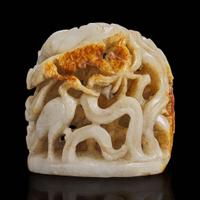A Chinese reticulated white and russet jade finial 透雕玉炉端