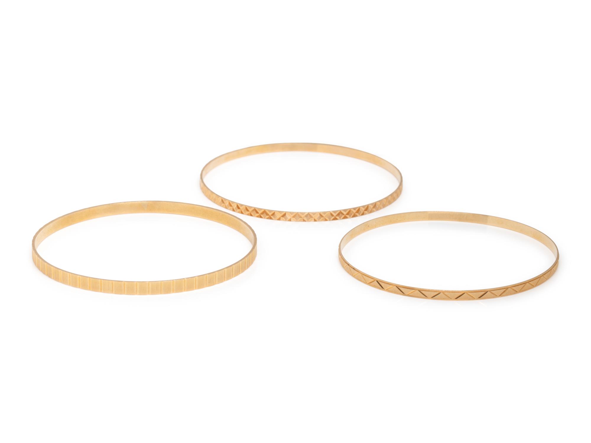 COLLECTION OF YELLOW GOLD BANGLE BRACELETS