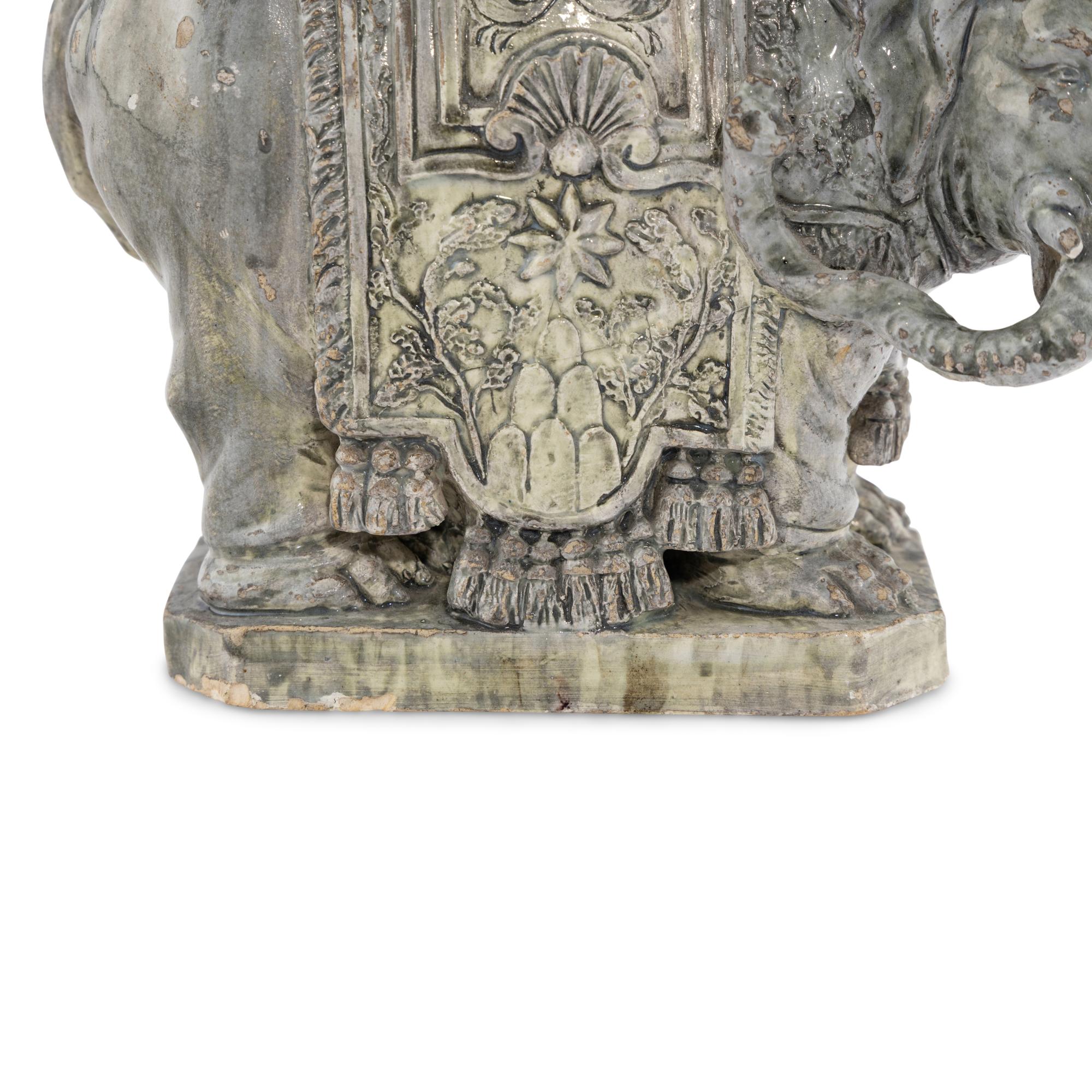 A Continental Gilt Bronze and Glazed Earthenware Elephant Obelisk