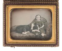 [EARLY PHOTOGRAPHY]. Quarter plate daguerreotype of a young girl posed with her dog.