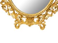 An Italian Rococo Style Carved Giltwood Oval Mirror and a Pair of Wall Brackets — 19TH/20TH CENTURY