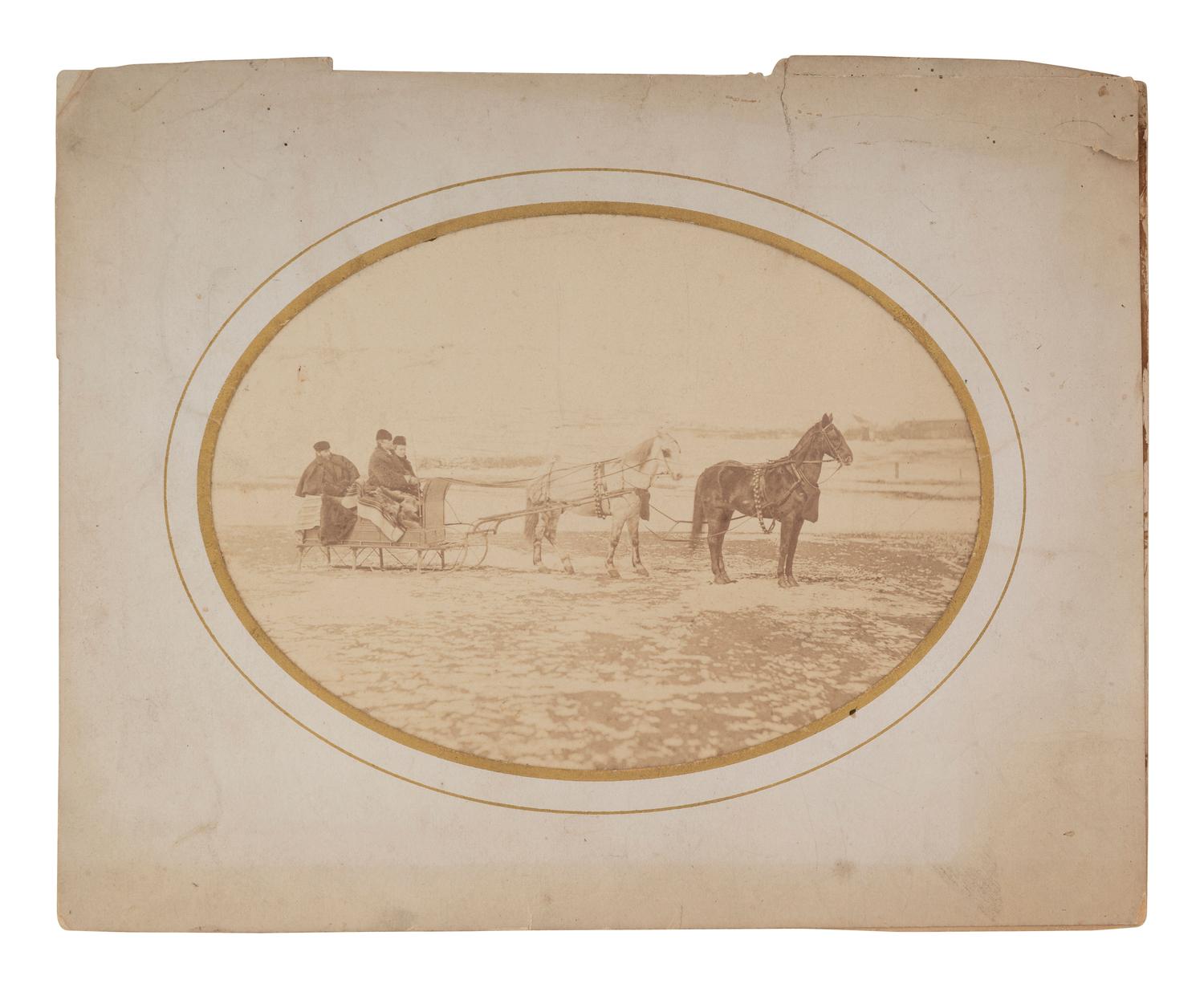 [WESTERN AMERICANA]. Albumen photograph featuring Tom Custer, Nellie Wadsworth, and William W. Cooke on a sleigh ride. Ca 1875.