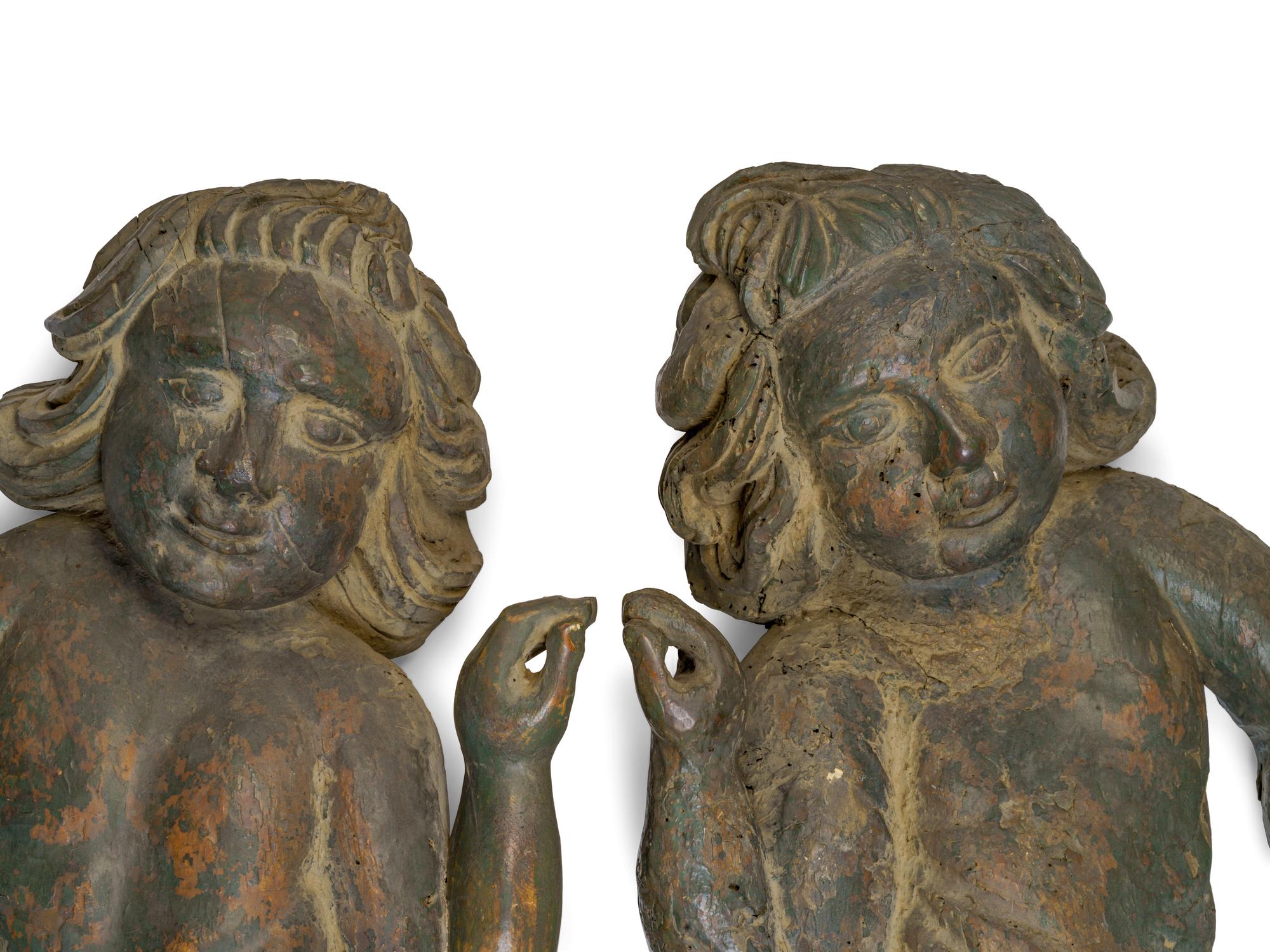 A Pair of Continental Carved and Painted Wood Putti