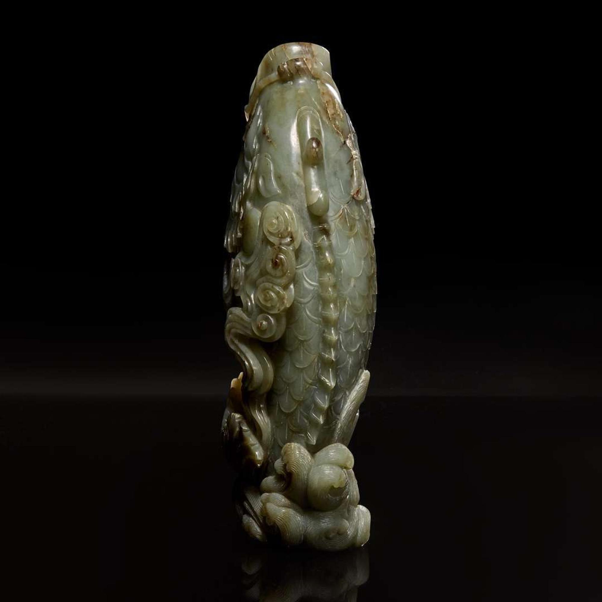 A Chinese carved celadon jade figure of a leaping carp 青玉鯉躍龍門花插