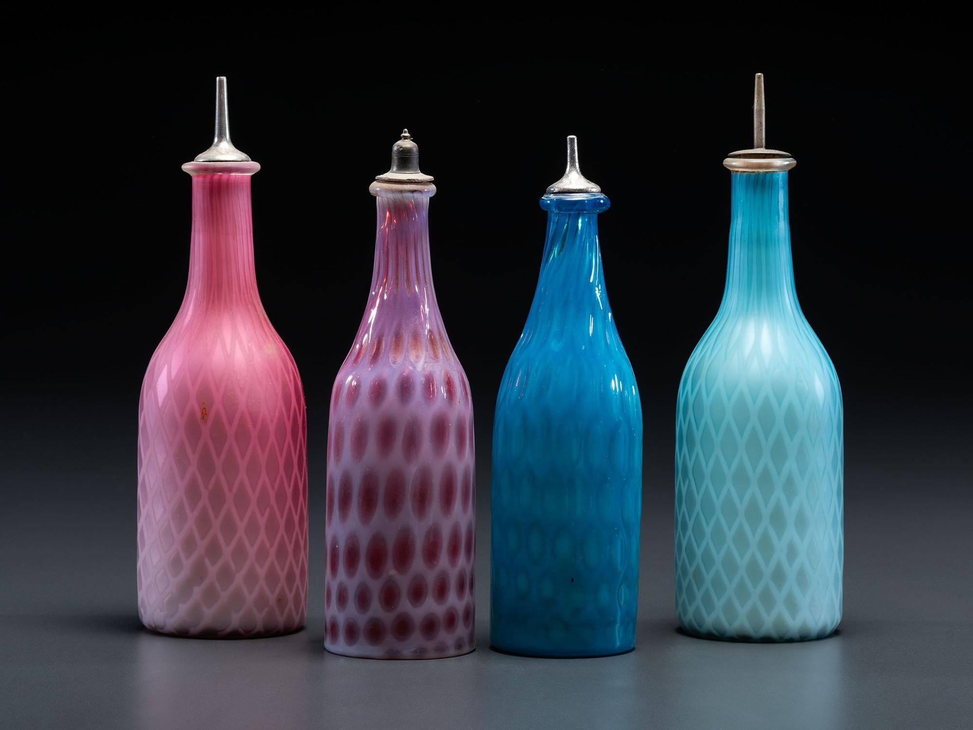 Four Opalescent Glass Barber Bottles