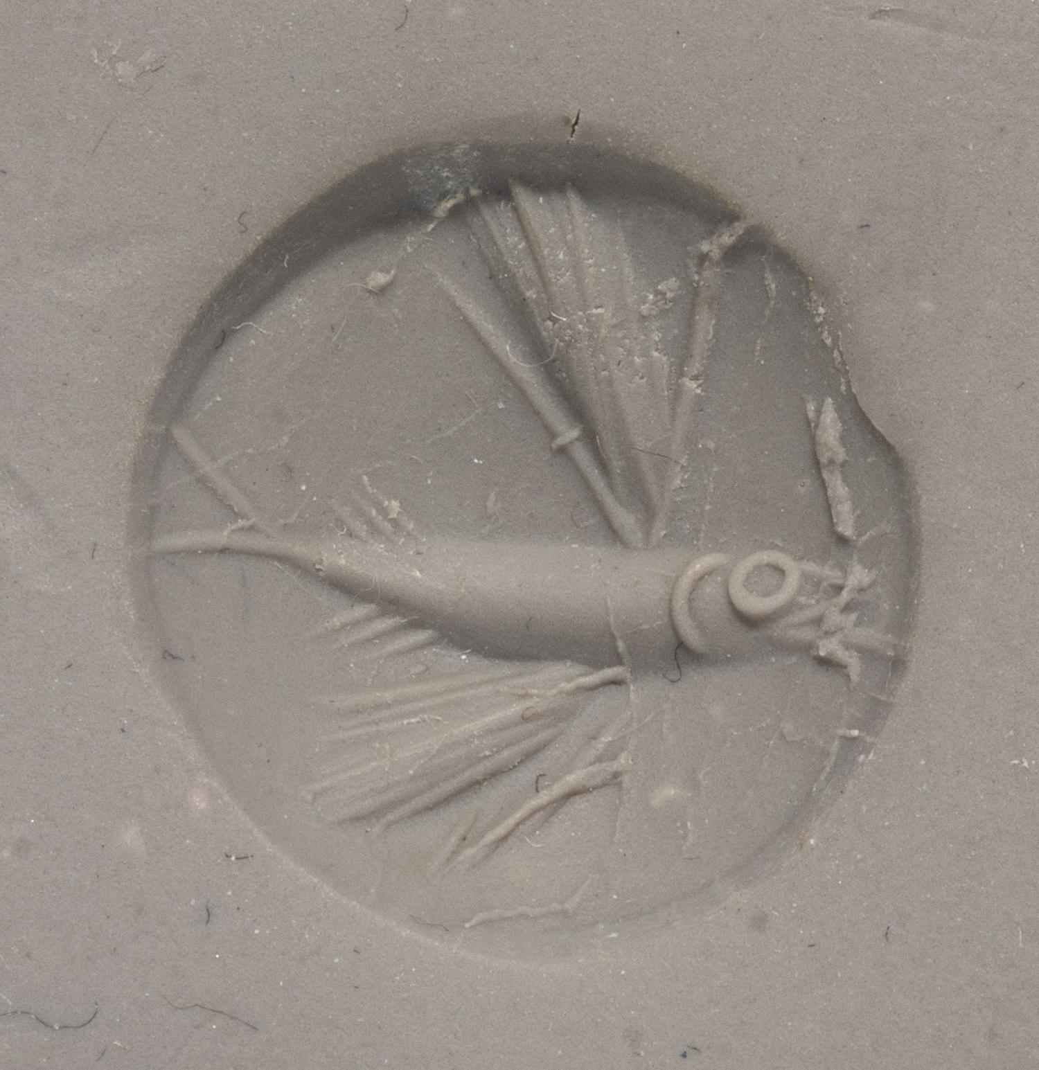 A Minoan Green Jasper Lentoid with a Flying Fish