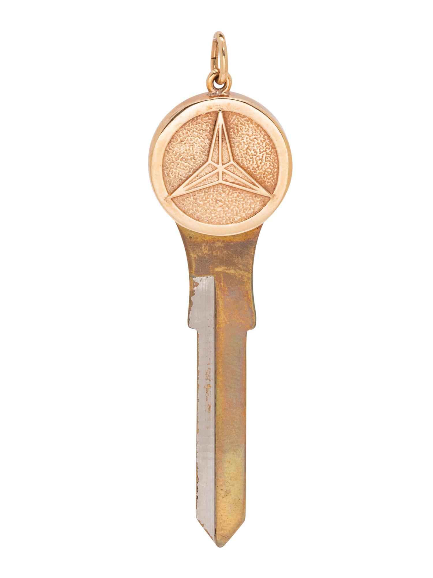 A 14 Karat Yellow Gold and Metal Car Blank Key Pendant,