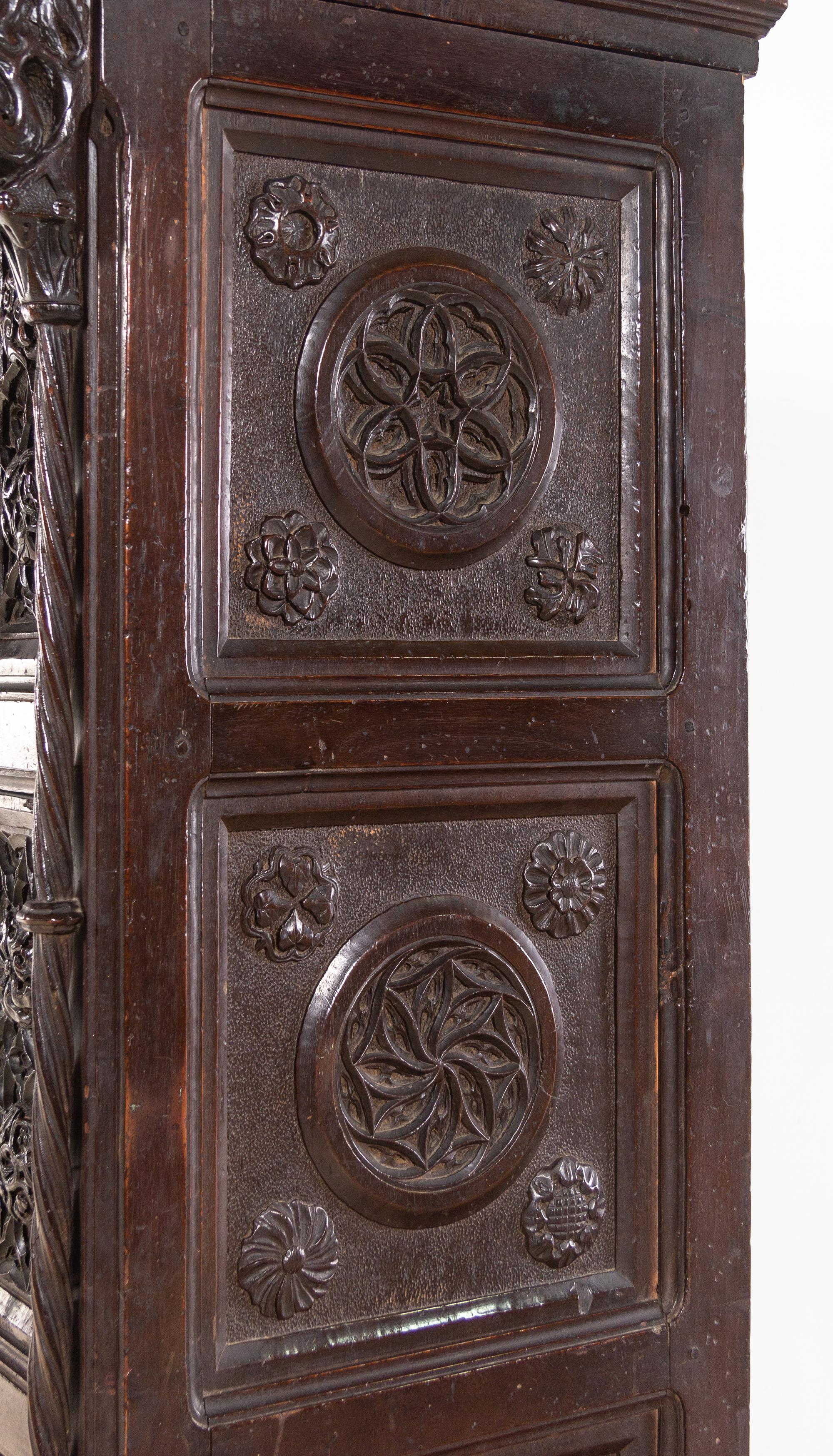 A Gothic Revival Carved Walnut Cabinet on Stand