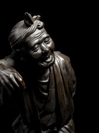 A Large Bronze Okimono of a Man