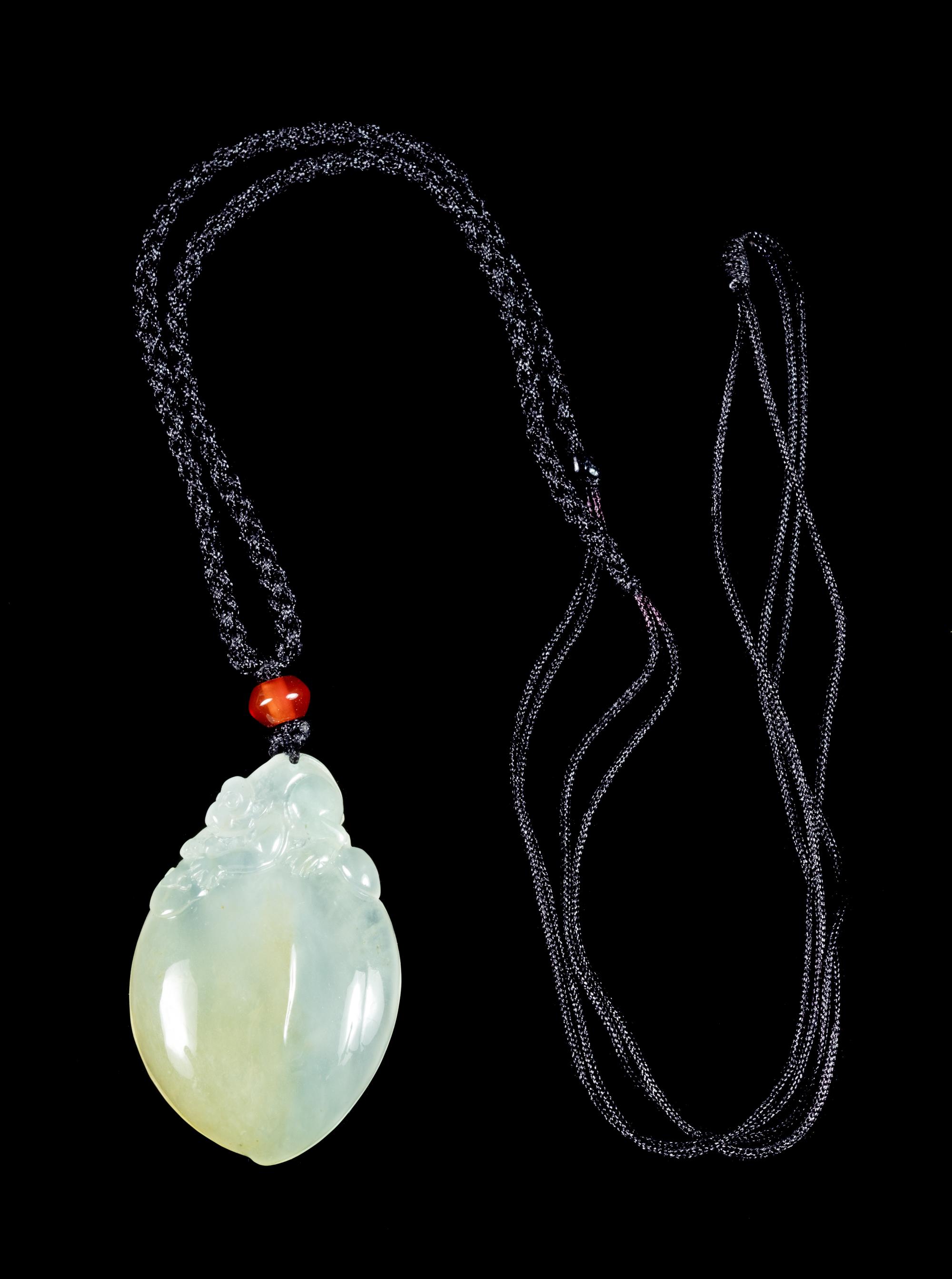 A Jadeite Peach-Form Pendant Length 1 1/2 inches. — 20TH CENTURY