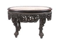 An Oval Chinese Export Marble Top Table Height 31 x width 48 x depth 31 1/4 inches.
