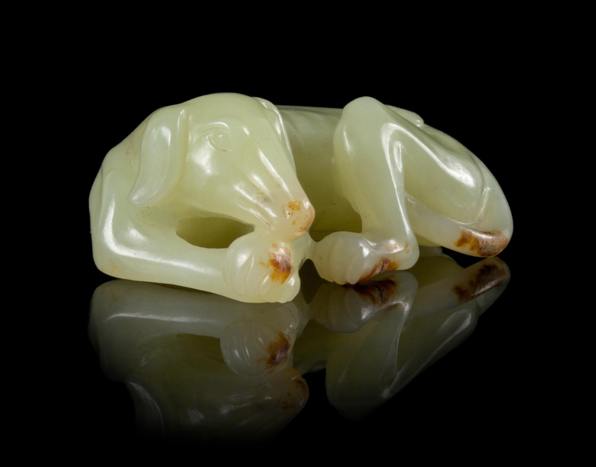 A Yellow Jade Figure of a Recumbent Dog Length 2 1/4 inches.