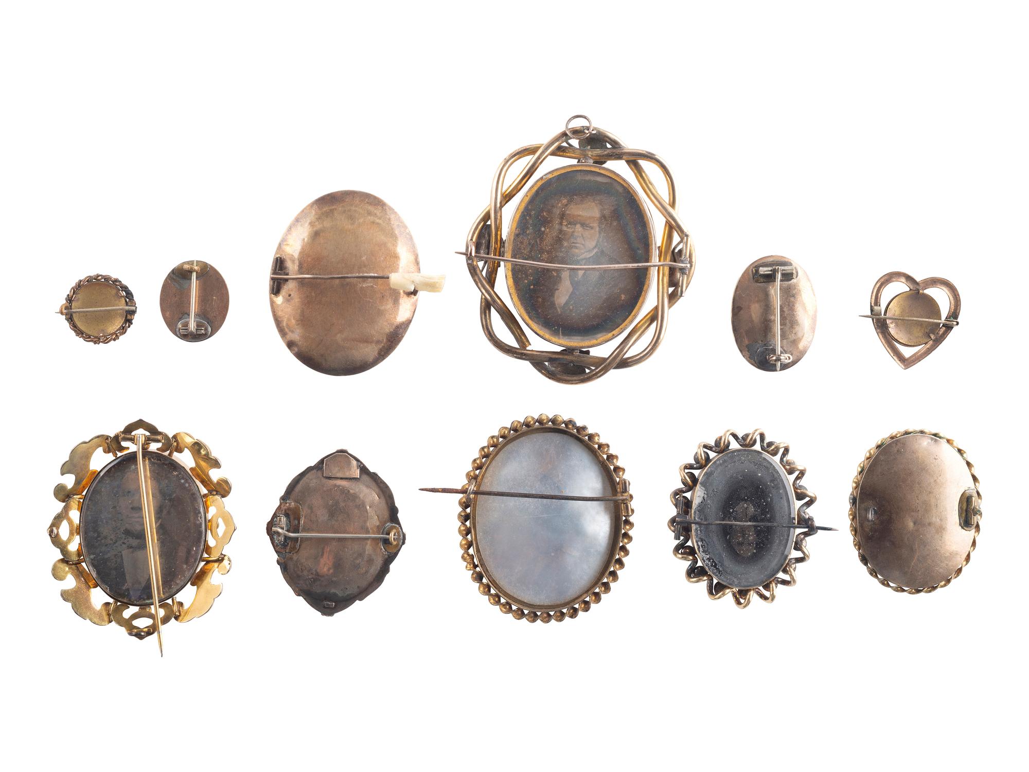 [EARLY PHOTOGRAPHY]. A group of 11 daguerreian brooches containing 13 portraits of men and women.