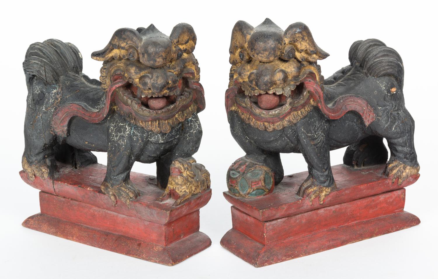 A Pair of Chinese Carved and Painted Foo Dogs Height 9 inches.
