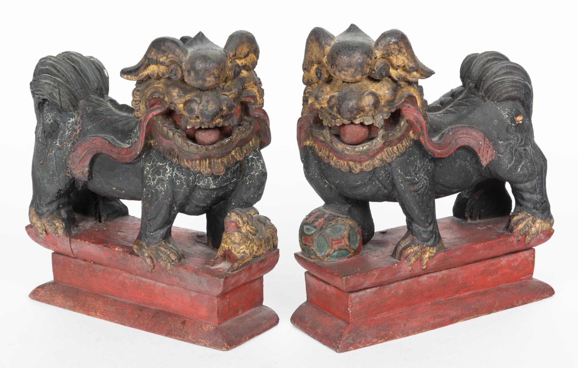 A Pair of Chinese Carved and Painted Foo Dogs Height 9 inches.