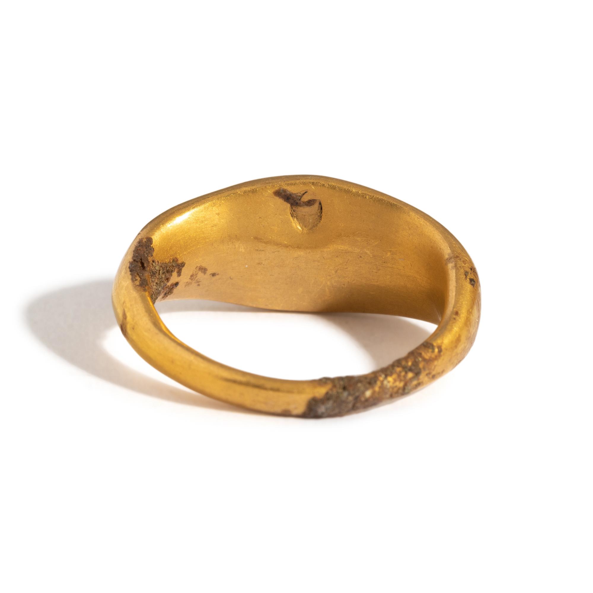 A Greek Gold and Garnet Finger Ring with a Prancing Stag