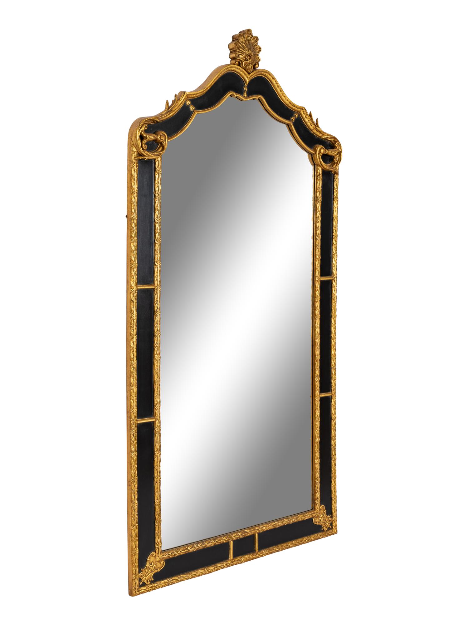 A Pair of Large Ebonized and Parcel Gilt Pier Mirrors