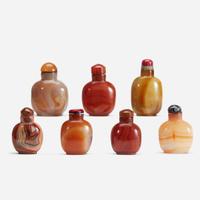 An assorted group of seven Chinese carnelian and agate snuff bottles