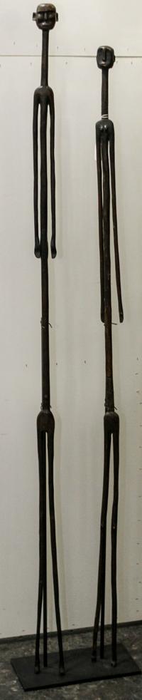 Two African Carved Wood Figures Height overall 64 inches.
