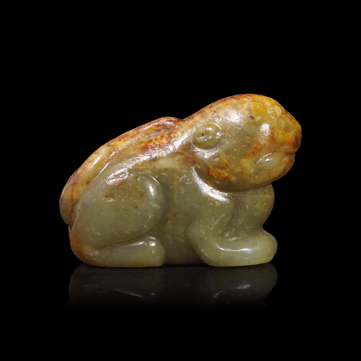 A Small Chinese Brown and Celadon Jade Mythical Beast, Ming Dynasty or Earlier 明或更早 青玉瑞獸