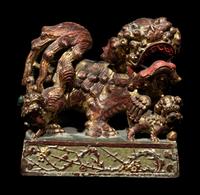 A Chinese Red and Gilt Lacquered Stone 'Buddhist Lion' Paperweight
