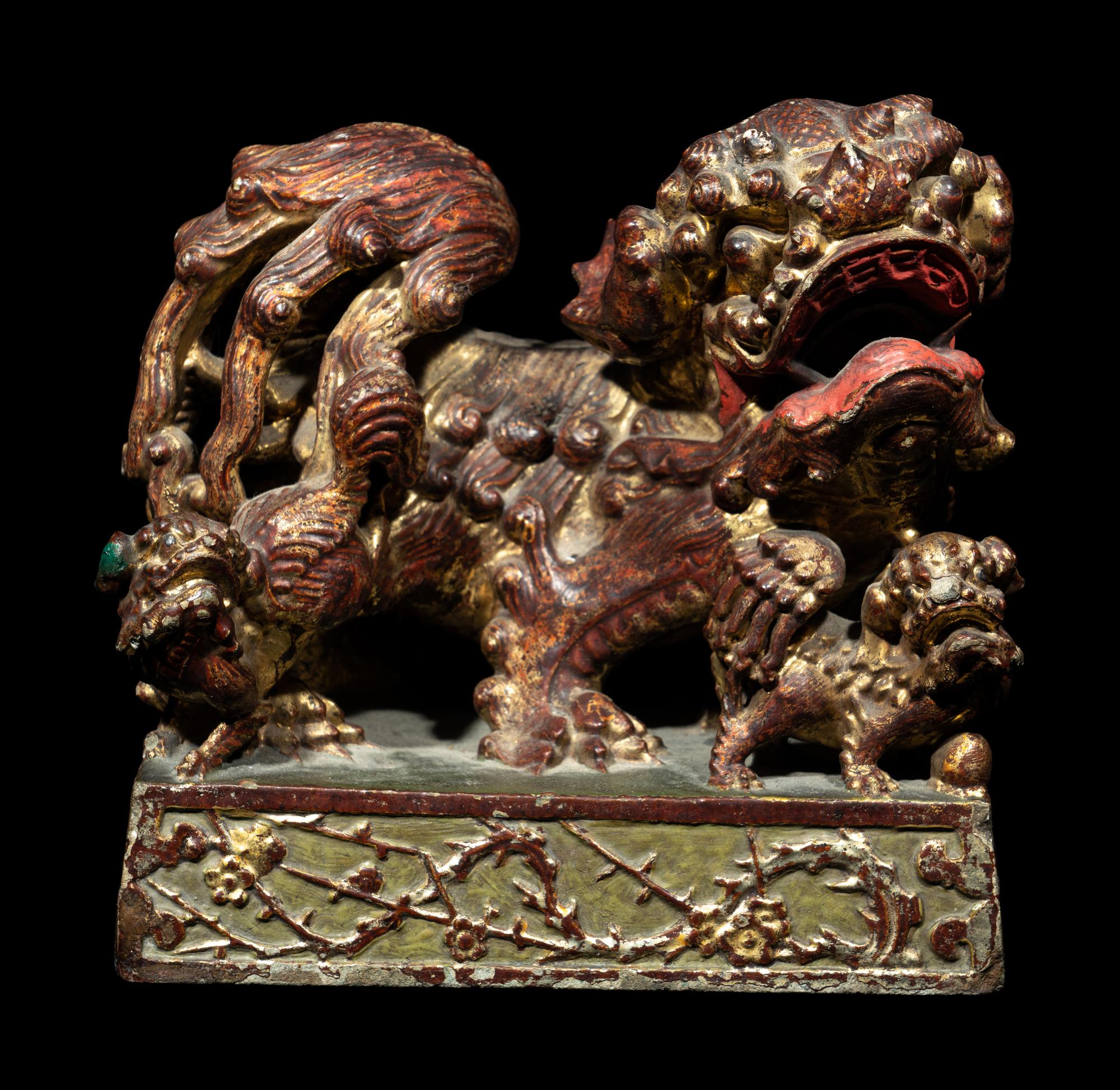 A Chinese Red and Gilt Lacquered Stone 'Buddhist Lion' Paperweight