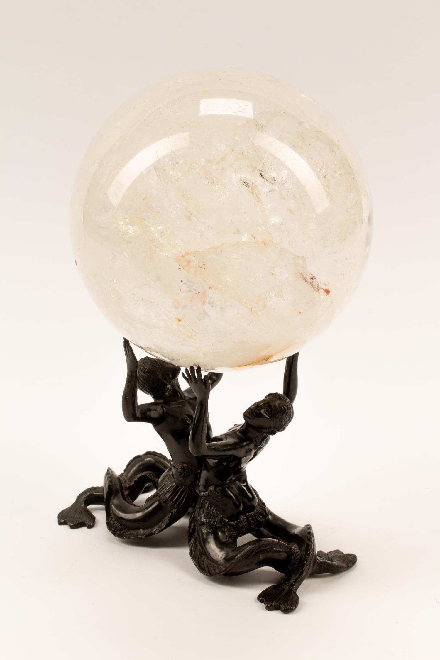 A Rock Crystal Spherical Ornament on a Patinated Bronze Figural Base